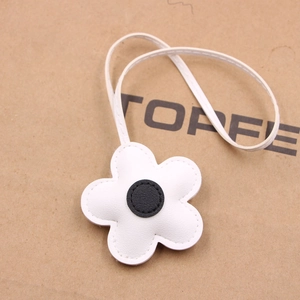 White cherry blossom flower leather bag charm with black center and thin white strap
