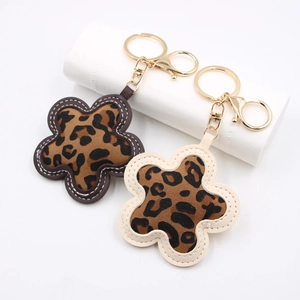 Leopard print flower keychain with gold plating and fine stitching on white background