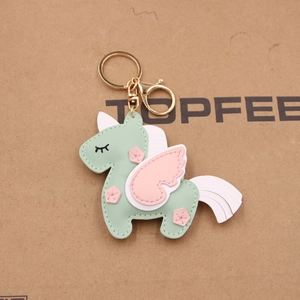 Handmade unicorn leather bag charm in mint green and pink with golden metal hardware