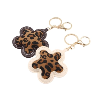 Pair of leopard print flower keychains with gold metal rings and lobster clasps