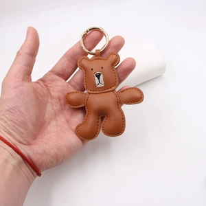 Handcrafted brown leather bear keychain charm with embroidery and gold metal ring