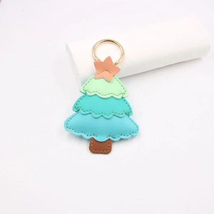 Detailed view of layered leather Christmas tree keychain with fine hand-stitched craft
