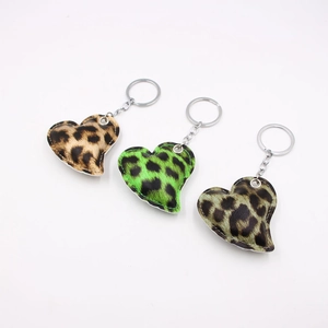 Set of three leopard print heart-shaped leather keychains in brown, green and emerald