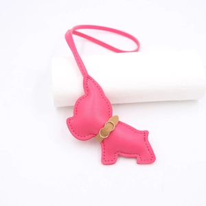 Close-up of pink faux leather french bulldog charm with fine stitching and lanyard