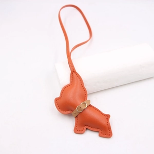 Detail of orange leather French Bulldog bag charm with fine stitching and small collar