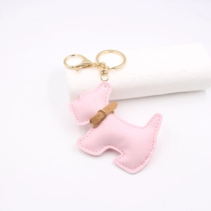 Detailed view of a pink leather Schnauzer keychain with premium golden metal hardware