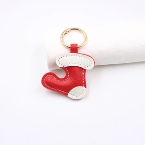 Litchi pattern leather Christmas boot keychain with red white stitching and gold ring