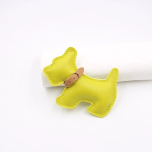 Macro detail of dog shaped leather accessory with fine stitching and collar
