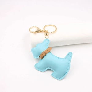 Detail of light blue leather Schnauzer keychain with premium stitching and golden hardware