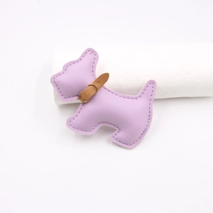 Close-up of light purple leather puppy charm with handcrafted stitching and brown collar