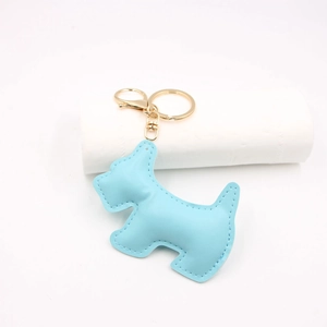 Close-up of sky blue leather Scottie dog keychain with gold-tone metal hardware