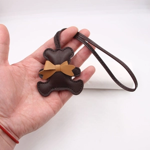 Cute dark brown leather bear keychain charm with yellow bow and long lanyard strap