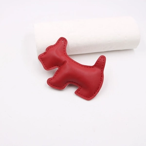 Detail of red leather Scottish Terrier puppy charm with fine stitching and top hole