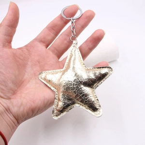 Golden star-shaped faux leather keychain with snake skin texture and metal ring