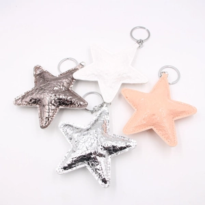 Set of four glittering star-shaped leather keychains in various metallic colors