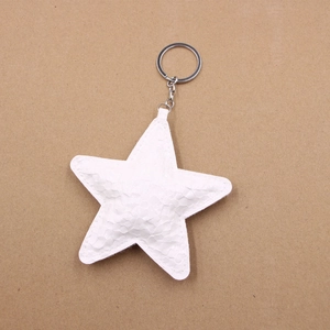 Detail view of white star leather keychain with snake texture and silver metal ring