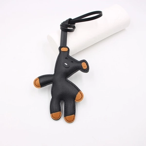 Detail showing high-quality stitching on black and brown leather horse bag charm