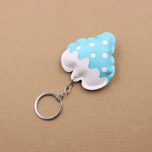 Close-up of sky blue strawberry leather keychain with fine stitching and silver metal hook