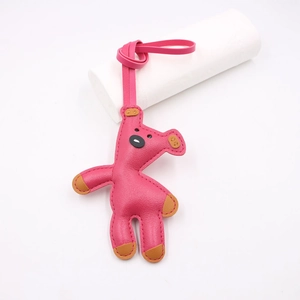 Detail of handmade bright pink leather teddy bear charm with a matching strap