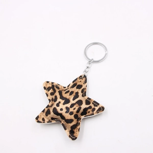 Star-shaped keychain with leopard print fabric and silver metal chain on white background