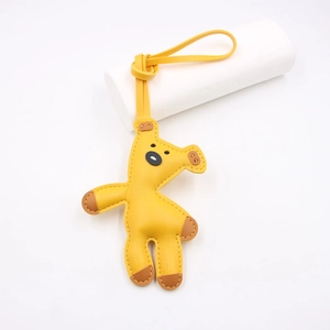Cartoon giraffe leather bag charm in yellow with premium pebble grain and lanyard