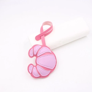 Detailed view of pink and purple croissant leather charm with high-quality stitching