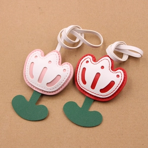 Detailed view of pink and red leather tulip charms with high-quality stitching and green stems