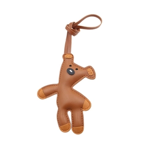 Cartoon brown leather bear bag charm with uniform stitching detail on white background