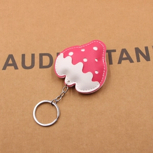 Close-up of pink and white PU leather strawberry keychain with fine stitching detail