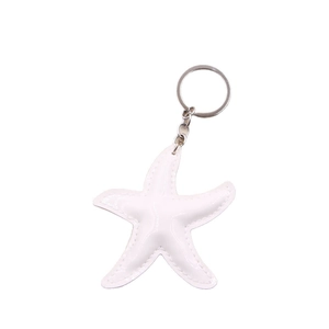 Minimalist white starfish leather keychain with silver metallic ring and fine stitching