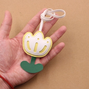 Handmade leather tulip bag charm with white and yellow petals and green leaves