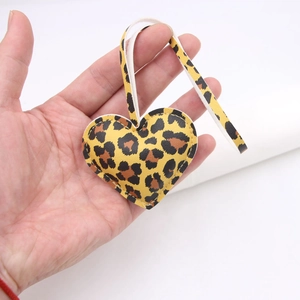 Detailed view of a leopard print heart keychain made of stitched synthetic leather