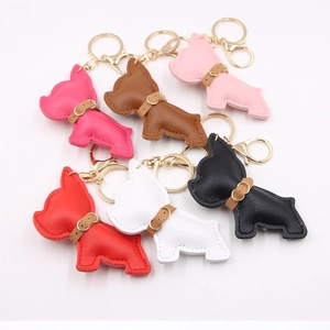 Close-up of leather French Bulldog keychains in multiple vibrant colors with golden hardware
