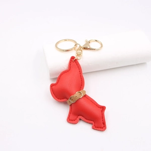Detail view of red leather bulldog keychain with gold spring clasp and top stitching