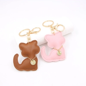 Pink and brown faux leather cat-shaped keychains with golden lobster clasps and key rings