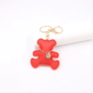 Detail of red leather bear keychain featuring gold chain and lobster clasp