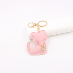 Pink faux leather kitten bag charm with gold metal clasp and detailed stitching