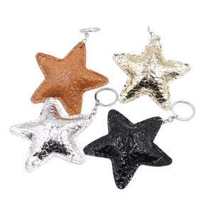 Star shaped leather keychains in black, gold, silver and brown with snakeskin texture