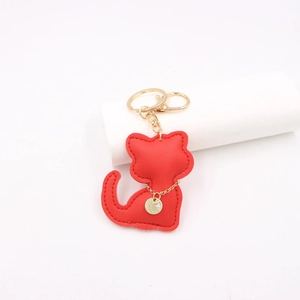 Close-up of red leather cat keychain with gold Best Wish charm and sparkling rhinestone detail