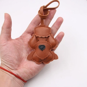 Handmade brown leather poodle dog bag charm with fine stitching and top strap detail