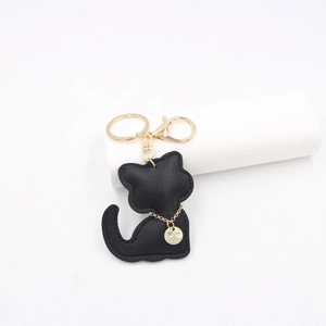Detailed view of black faux leather cat keychain with gold chain and lobster clasp