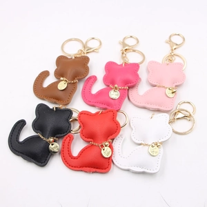 Detail of cute cat leather keychains in brown, pink, black, red and white colors