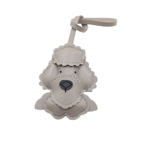 Gray leather poodle bag charm with white stitching and 3D stuffed design for handbag decor
