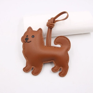 Close-up of brown litchi pattern leather dog pendant with meticulous double stitching