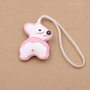 Détail du charm corgi en cuir PU rose et blanc avec découpe en étoile et lanière blanche