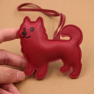 Red lychee pattern leather dog charm with matching hand-stitched lanyard detail
