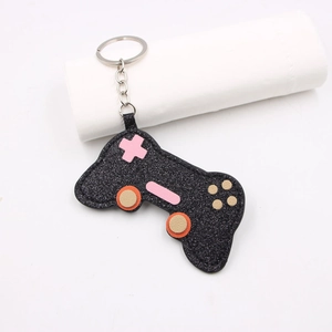 Sparkly black glitter game controller keychain with colorful buttons and silver metal ring