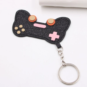 Sparkly glitter gamepad keychain accessory with pink buttons and silver metal ring