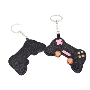 Sparkling black glitter leather game controller keychain with metallic ring and pink buttons