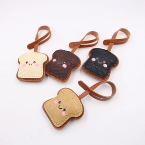 Detailed view of leather toast bag charms in four colors with cute facial expressions